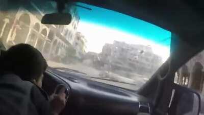 Car drives right though a russian cluster strike. Douma, Syria November 2017