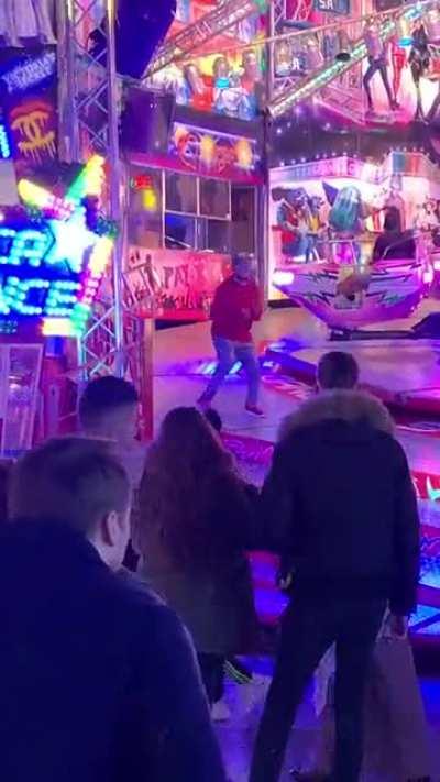 Total stranger steals the show on a local fairground attraction in Belgium