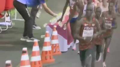 Marathon - One for me...none for you. Morhad Amdouni (FRA) grabs a refreshment at the water station