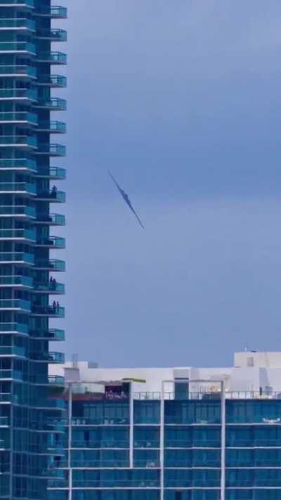 A B-2 Spirit stealth strategic bomber flying over Miami beach.