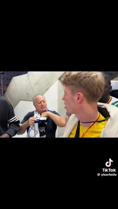 A fan of the Israel national football team interrupts the interview of a spectator at the Mali vs Israel game at the Paris 2024 Olympics.  