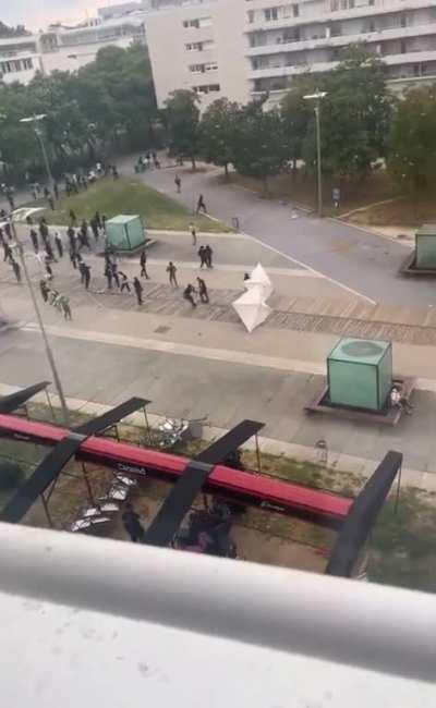 This guy eating a sandwich right between the rioters and the police in Nanterre, France