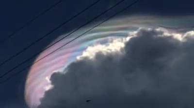 Rainbow cloud caused by light refracting through ice crystals