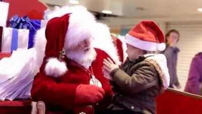 Santa using sign language to speak to this child. Merry Christmas everyone!