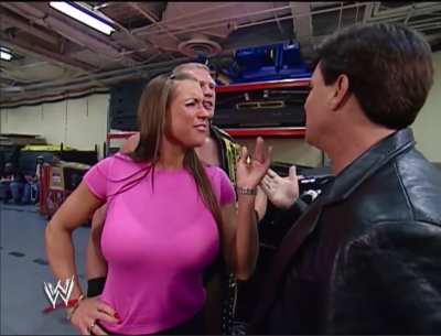 Stephanie McMahon backstage with Eric Bischoff and Brock Lesnar