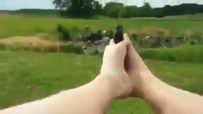 man shooting pistol with his feet