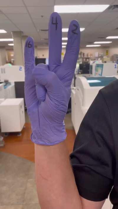 Engineer demonstrates how to count to 31 with one hand starting with zero. 