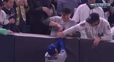 Baseball fan forces ball out of players mitt