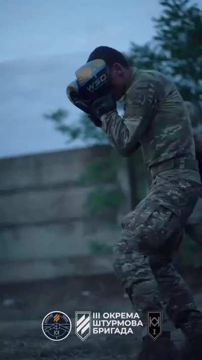 Soldiers of the 1st Mechanized Battalion of the 3rd Assault Brigade keep themselves fit with boxing