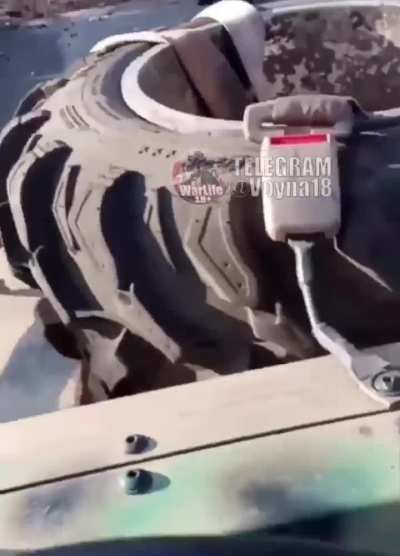 Russian military man shows the result of an FPV drone attack on a Desertcross-1000-3 all-terrain vehicle of the Russian Armed Forces near Avdiivka