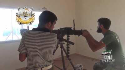 FSA affliated fighters harass an SAA staging area with a large MG from indoors - Daraa - 8/17/2014