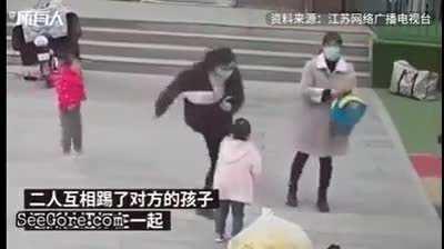 Two women kicking each other's kids