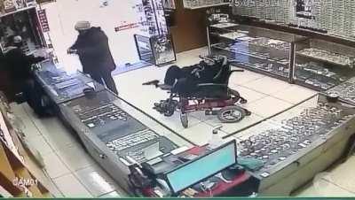 Robbing a jewelry in a wheelchair with a gun on his feet