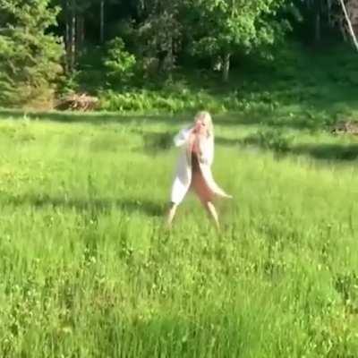 A woman walking on floating grass in Lithuania