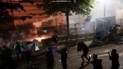 Riots in portland last night, featuring fire, lasers, fireworks, and projectiles