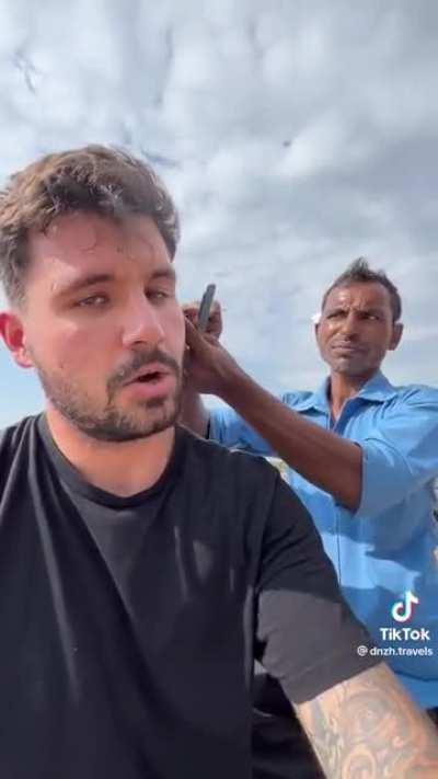 A man cleaning tourists ears