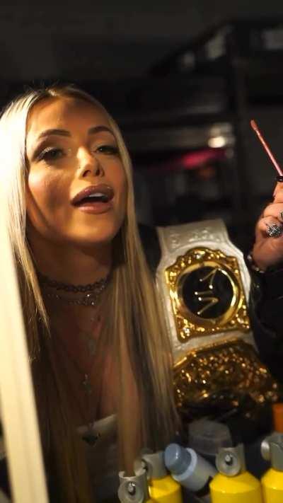 Liv putting on lipgloss backstage 6/10/24