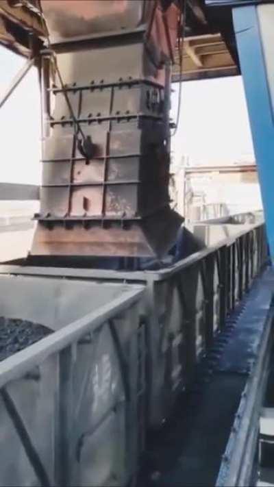 This coal loading chute in China loads the coal and smooths it down.