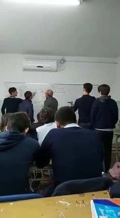 Guy aim a gun at their teacher