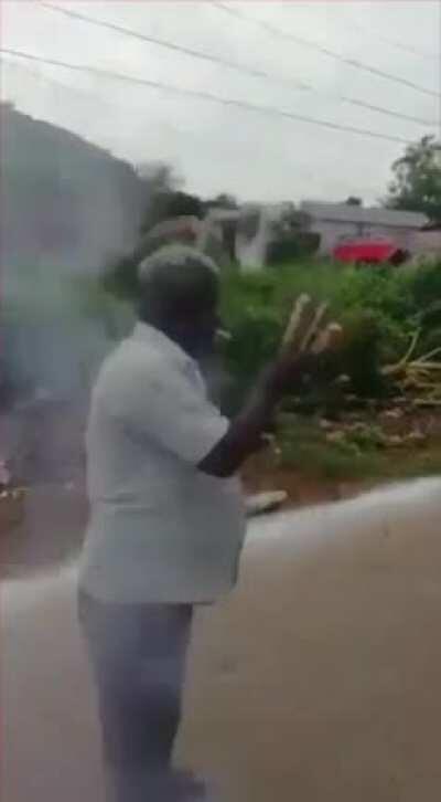 Man lighting fireworks with cigarette