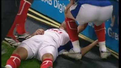 Soccer player knocks out his opponent during a match.