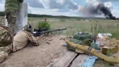 Sniper from a Special Operations Service is practicing his aim by using a Ukrainian large caliber Sniper-T-Rex rifle. The max. range of this &quot;baby&quot; is 7 km.