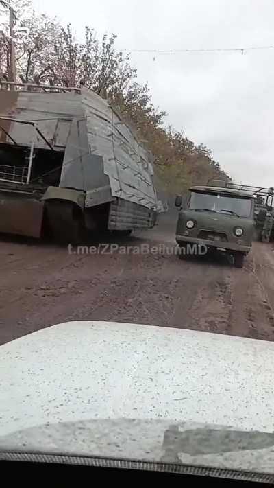 RU POV: Russian &quot;Turtle&quot; tank running past troops and vehicles nicknamed: &quot;Босс мангалов&quot; Barbeque boss.