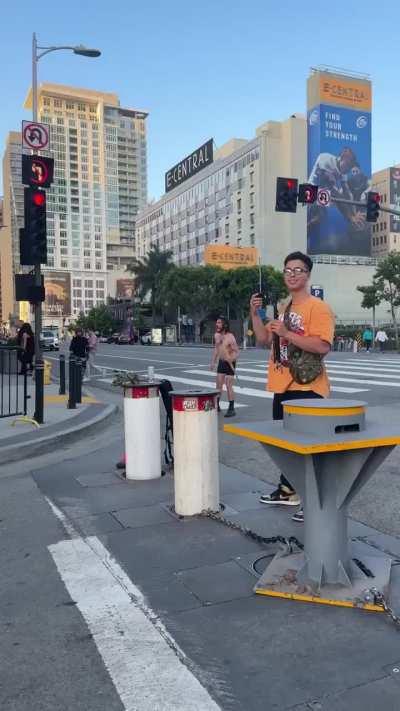 Shirtless guy with guitar case screaming outside Biden's LA fundraiser about Obama and says he has a gun in the guitar case 