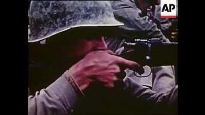 A U.S. Marine fires his M1903 Springfield rifle at Japanese forces during the Battle of Okinawa, c. 1945