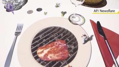 A tiny chef, projected onto the table, turning each plate into a grill and preparing a virtual steak for the guests