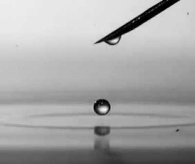 A drop of water falls into the water, filmed with a high-speed video camera.