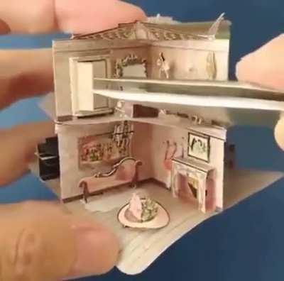 A tiny pop-up dollhouse in a book