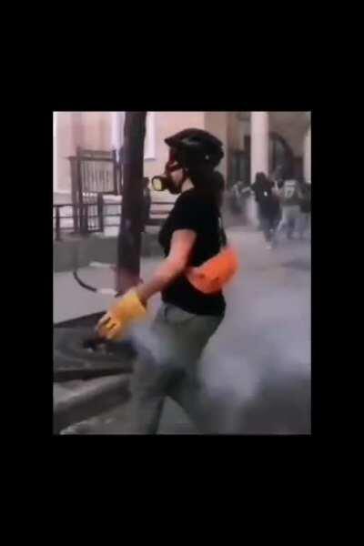 A brave girl sending back a smoke grenade to security forces in Beirut with tennis racket