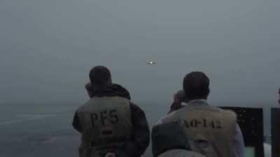 Landing on an aircraft carrier in heavy rain.