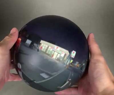 A 360° painting of a night scene on a sphere plays tricks with perspective.