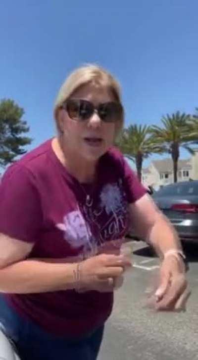 Woman sits on a girls car to reserve a parking spot