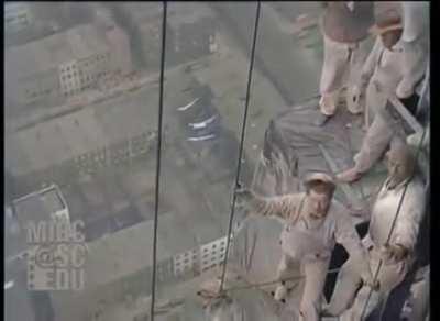 Colorised footage from 1929 of construction workers on THE CHRYSLER BUILDING in NEW YORK.