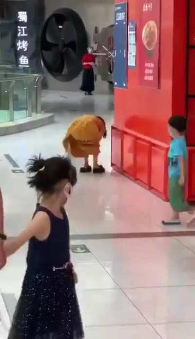 A woman in Beijing’s Shijingyan Wanda Plaza after she received a phone call confirming she tested positive for COVID-19