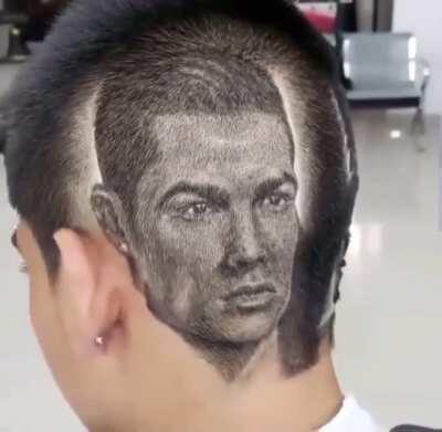 Barber cuts a portrait of Cristiano Ronaldo.