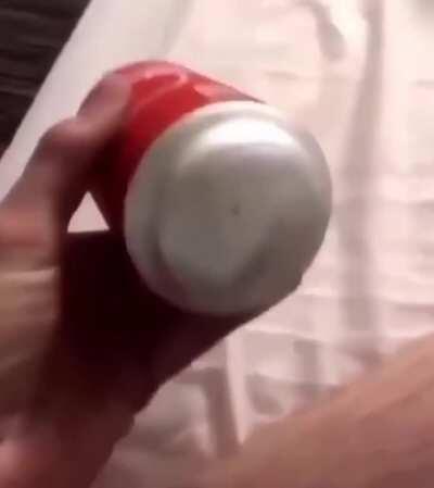 Opening an inflated can of coke