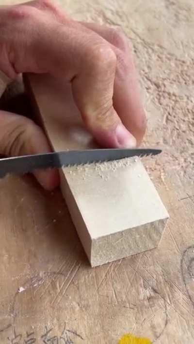 Carving A Block Of Wood With A Chisel To Make Little Characters