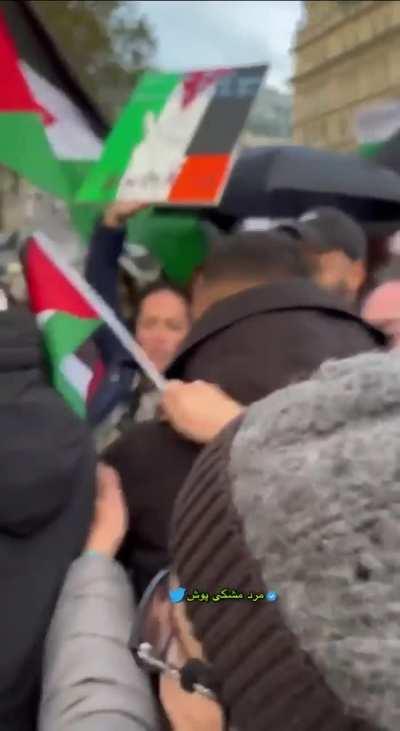 Man holds up sign saying &quot;Hamas is terrorists&quot; during protest in London.