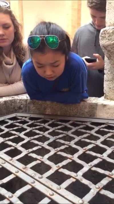 Girl singing into well