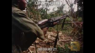 US Army M-60 gunner lays down a hail of suppressive fire in Vietnam - 1967