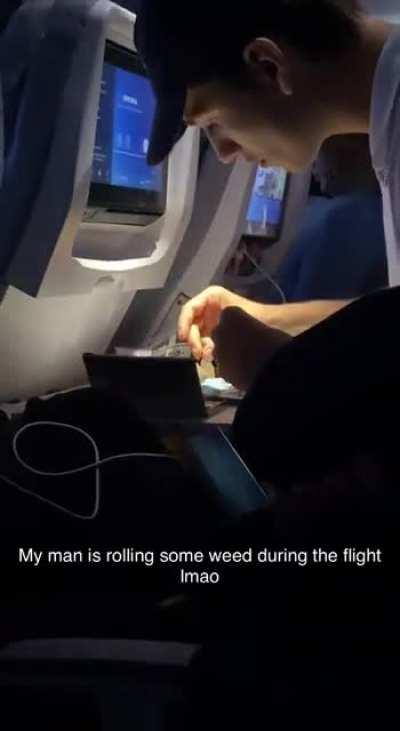 He is rolling cigs on an international flight