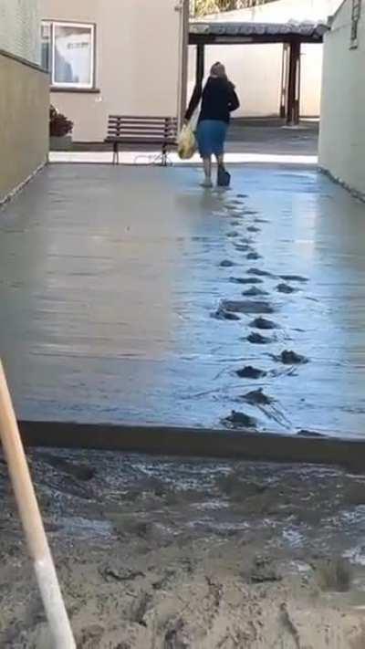 Lady decides to walk through wet cement