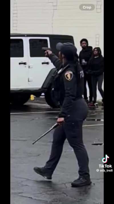 Police officer in Dolton Illinois aims her gun at a group of high school students