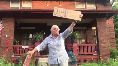 This 83 year old woman holding a sign that says “Defend black voices”