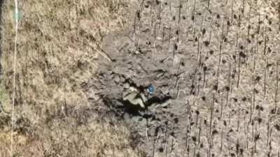 RU POV: A Russian soldier lying in a crater is shocked by a FPVdrone strike that did not detonate 