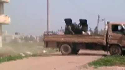 Opposition flat-bed technical gets rocking under the recoil of a ZU-23-2 - Daraa - 2013